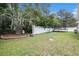 Large backyard with mature trees, trampoline, and white fence at 7007 Blade Beak Ln., Myrtle Beach, SC 29588