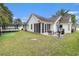 Expansive backyard with patio seating area and well-manicured lawn at 7007 Blade Beak Ln., Myrtle Beach, SC 29588