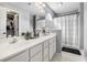 Bathroom featuring a double vanity, walk-in shower with a shower curtain and an arched window at 7007 Blade Beak Ln., Myrtle Beach, SC 29588