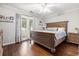Bedroom with hardwood floors, ceiling fan, and private access to screened-in porch at 7007 Blade Beak Ln., Myrtle Beach, SC 29588