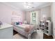 bedroom featuring light pink walls, a white metal bed frame and plush toys at 7007 Blade Beak Ln., Myrtle Beach, SC 29588