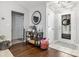 Inviting foyer featuring hardwood floors, a decorative mirror, and a view of the front door at 7007 Blade Beak Ln., Myrtle Beach, SC 29588
