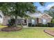 Charming brick home with blue shutters, manicured landscaping, and a welcoming front entrance at 7007 Blade Beak Ln., Myrtle Beach, SC 29588