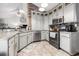 Well-lit kitchen with stainless steel appliances, granite countertops, beautiful tile backsplash and flooring at 7007 Blade Beak Ln., Myrtle Beach, SC 29588