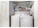 Laundry room featuring a white washer and dryer, shelving and white door at 7007 Blade Beak Ln., Myrtle Beach, SC 29588