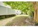 View of the backyard with a white vinyl fence and a patio with steps at 702 Beach Walk Pl. # 702, Myrtle Beach, SC 29577