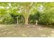 View of the backyard featuring mature trees, shrubbery, birdhouses and a bird bath at 702 Beach Walk Pl. # 702, Myrtle Beach, SC 29577