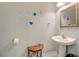 Clean bathroom with pedestal sink, elegant mirror, and stylish wall decor at 702 Beach Walk Pl. # 702, Myrtle Beach, SC 29577