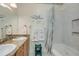 Bathroom featuring double sinks, granite counters, and shower and tub combo at 702 Beach Walk Pl. # 702, Myrtle Beach, SC 29577