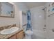 Functional bathroom with tub and shower, vanity with storage, and coastal-themed accents at 702 Beach Walk Pl. # 702, Myrtle Beach, SC 29577