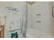 Bathroom shower/tub combo with tiled walls and shower niche at 702 Beach Walk Pl. # 702, Myrtle Beach, SC 29577