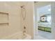 Bathroom tub and shower with view to bedroom at 702 Beach Walk Pl. # 702, Myrtle Beach, SC 29577