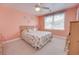 Bright and airy bedroom with beach themed decor, a ceiling fan, and natural light at 702 Beach Walk Pl. # 702, Myrtle Beach, SC 29577