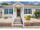 Exterior shot of the building featuring dual entrances, a white railing, and colorful, decorative shutters at 702 Beach Walk Pl. # 702, Myrtle Beach, SC 29577