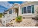 Charming home featuring a quaint front porch with stone landscaping and vibrant green shutters at 702 Beach Walk Pl. # 702, Myrtle Beach, SC 29577