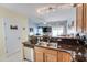 Open concept kitchen with stainless dishwasher, double sinks, breakfast bar, and view to sitting area at 702 Beach Walk Pl. # 702, Myrtle Beach, SC 29577