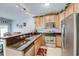 Traditional kitchen with stainless steel appliances, granite counters, and light wood cabinetry at 702 Beach Walk Pl. # 702, Myrtle Beach, SC 29577