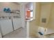 Convenient laundry room with washer, dryer, and storage shelving near the bedroom at 702 Beach Walk Pl. # 702, Myrtle Beach, SC 29577