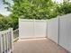 Private tiled patio area enclosed by a white fence, perfect for outdoor entertaining at 702 Beach Walk Pl. # 702, Myrtle Beach, SC 29577