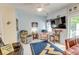 Comfortable sitting room with ceiling fan, TV, plush chairs, and view to backyard through sliding doors at 702 Beach Walk Pl. # 702, Myrtle Beach, SC 29577
