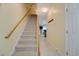 Carpeted staircase leading to the upper level of the home, featuring a wooden handrail at 702 Beach Walk Pl. # 702, Myrtle Beach, SC 29577