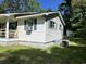 Exterior view of the home with window unit and green shutters at 76 Lyerly Rd., Hemingway, SC 29554