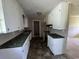 Kitchen with white cabinets, marbled counter tops, and updated flooring at 76 Lyerly Rd., Hemingway, SC 29554
