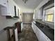 Kitchen featuring white cabinetry, neutral walls and updated flooring at 76 Lyerly Rd., Hemingway, SC 29554