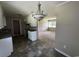 Kitchen showcasing white cabinetry, a chandelier and vinyl flooring at 76 Lyerly Rd., Hemingway, SC 29554