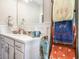 Bright bathroom with white cabinets, quartz countertop, under cabinet storage, and decorative towel rack at 769 Country Club Dr., Pawleys Island, SC 29585