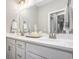 Bright bathroom with dual sinks, a large mirror, and a view into an adjacent room at 769 Country Club Dr., Pawleys Island, SC 29585