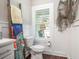 Bright bathroom with decorative seahorse and starfish decor, white cabinets, and unique towel rack at 769 Country Club Dr., Pawleys Island, SC 29585