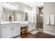 Spacious bathroom featuring double sinks, white cabinetry, a large mirror, and glass enclosed shower at 769 Country Club Dr., Pawleys Island, SC 29585