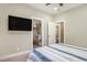 Bright bedroom features a TV and includes an ensuite bathroom and a well-organized closet at 769 Country Club Dr., Pawleys Island, SC 29585
