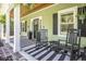 Welcoming front porch with rocking chairs and stylish striped rug at 769 Country Club Dr., Pawleys Island, SC 29585