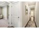 Hallway featuring white doors, wood flooring, and views into a bedroom and bathroom at 769 Country Club Dr., Pawleys Island, SC 29585