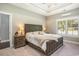 Calm and inviting bedroom with a tray ceiling, neutral walls, plantation shutters, and plush carpet at 769 Country Club Dr., Pawleys Island, SC 29585