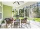 Spacious screened porch with wicker seating and views of wooded backyard at 769 Country Club Dr., Pawleys Island, SC 29585