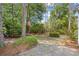 Well-maintained backyard with mature trees and an American flag at 86 Wickham Ct., Pawleys Island, SC 29585