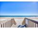 Walkway with stairs leads down to a sandy beach and the ocean for endless outdoor enjoyment at 86 Wickham Ct., Pawleys Island, SC 29585