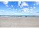 Wide sandy beach with gentle waves and clear skies offers a peaceful coastal experience at 86 Wickham Ct., Pawleys Island, SC 29585