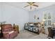 Bedroom featuring a ceiling fan and a sunlit window with wooden shutters at 86 Wickham Ct., Pawleys Island, SC 29585