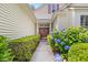 Inviting front entrance with double doors, lush landscaping, and a well-lit pathway leading to the home at 86 Wickham Ct., Pawleys Island, SC 29585