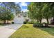 Charming home with a well-manicured lawn, mature trees, and a two-car garage, creating inviting curb appeal at 86 Wickham Ct., Pawleys Island, SC 29585