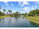 Picturesque pond with a fountain surrounded by lush landscaping and beautiful homes at 86 Wickham Ct., Pawleys Island, SC 29585
