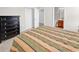 Comfortable bedroom featuring a striped quilt, dark dresser, and connecting bathroom for added convenience at 101 Culpepper Way # 1006, Myrtle Beach, SC 29579