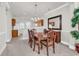 Elegant dining area features a stylish chandelier, neutral carpet, and seamless flow to the kitchen at 101 Culpepper Way # 1006, Myrtle Beach, SC 29579