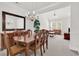 Spacious dining area features a chandelier, neutral carpet, and seamless flow to the living room at 101 Culpepper Way # 1006, Myrtle Beach, SC 29579