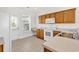 Bright kitchen featuring white appliances, ample counter space, and a convenient access door at 101 Culpepper Way # 1006, Myrtle Beach, SC 29579
