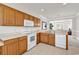 Functional kitchen with white appliances, wooden cabinets, and easy access to dining area at 101 Culpepper Way # 1006, Myrtle Beach, SC 29579